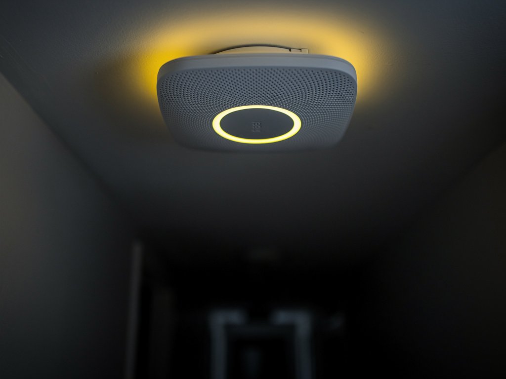 A Nest Protect showing a yellow Nightly Promise glow, indicating it will expire soon and needs replacement
